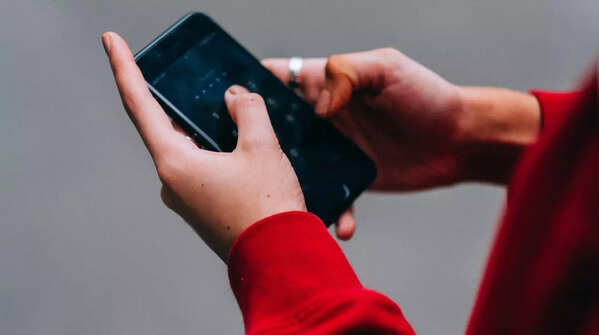Using both hands and thumbs to operate the phone