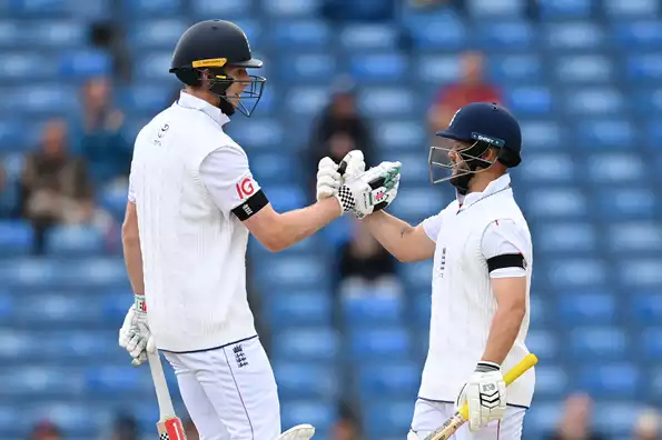 England's opening pair celebrates their partnership.